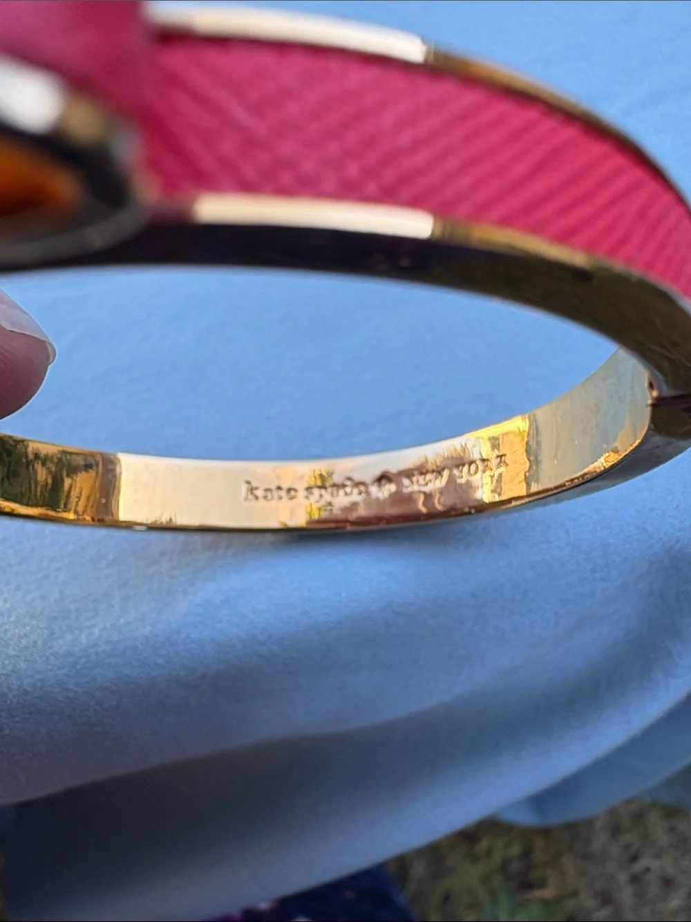 kate spade gold-tone bangle with pink enamel bow